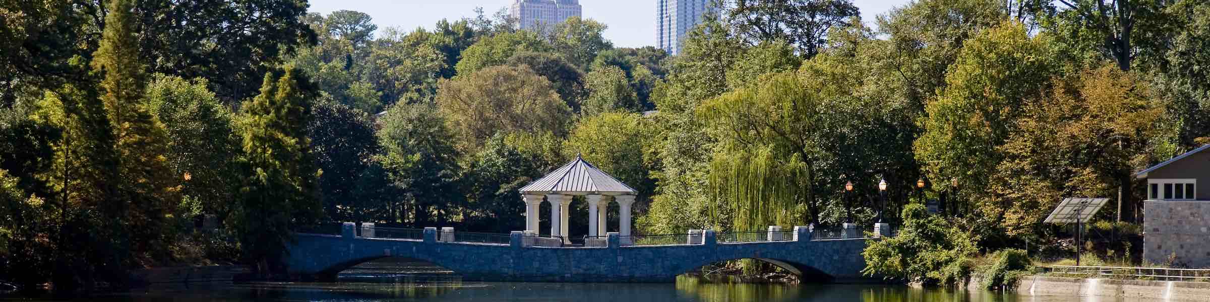 View of the lake in Piedmont Park, with skyscrapers in the background.